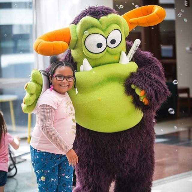Child with Remoc the Comer Children's mascot