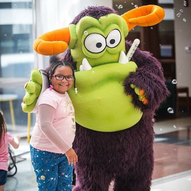 Child with Remoc the Comer Children&#039;s mascot