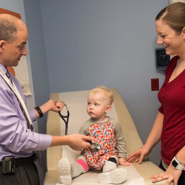 Doctor talks with baby and mother