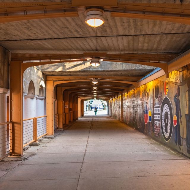 A bridge with murals on the wall