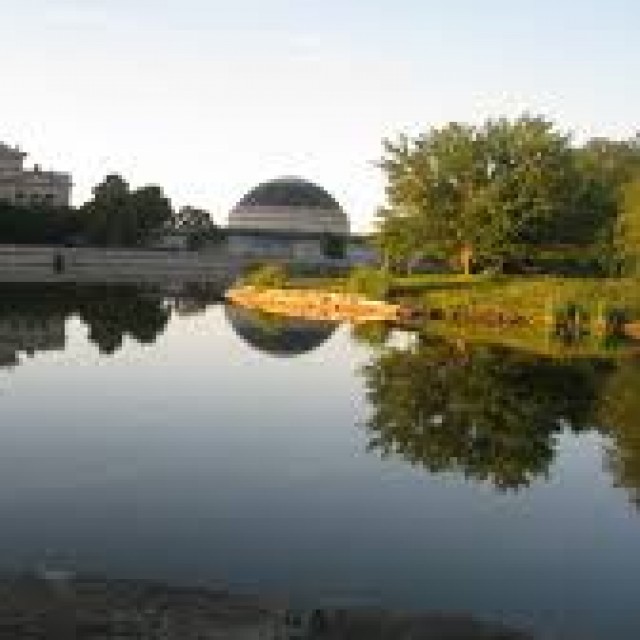 The Museum of Science and Industry, viewed over a lake 