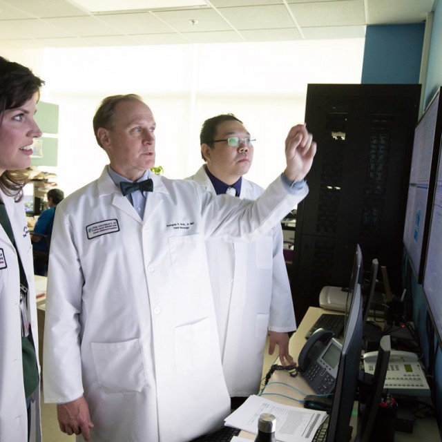 Douglas R. Nordli, Jr., MD talking about a scan with other doctors