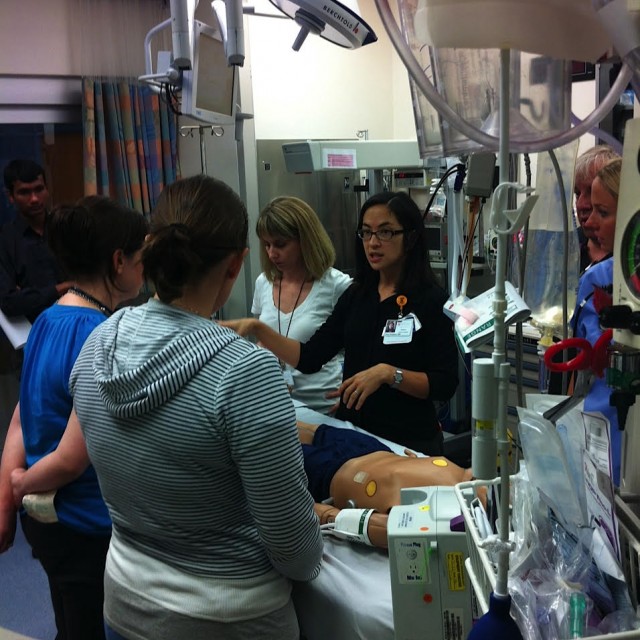 Medical providers simulating an emergency medical procedure